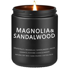 a candle that is sitting in front of a white background with the words magnolia and sandalwood on it