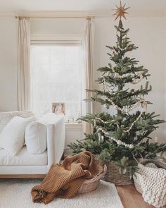 a living room with a christmas tree in the corner