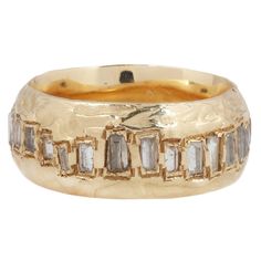 an 18k gold band with baguettes and diamonds