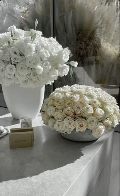 white flowers in a vase on a table