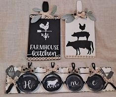 two farm themed signs hang on the wall next to plates and utensil holders