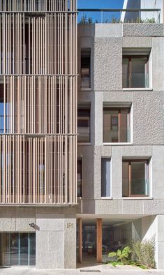 an apartment building with wooden slats on the facade