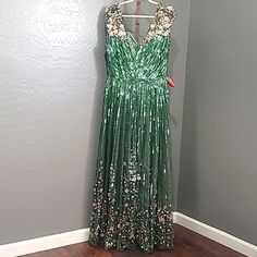 New With Tags Mac Duggal Sequin Floral Embellished Evening Gown Dress Sage Green Size 16 Floor-Length Evening Gown Cascading Sequin Stripes, Exquisite 3d Floral Embellishments At The Shoulders And Bottom Hem, And A Sweeping A-Line Hem. Mac Duggal Sequin Fabric (100% Polyester) Fully Lined V-Neck Cap Sleeve 3d Floral Embellishments Concealed Back Zipper Approx. 62.5" From Top Of Shoulder To Bottom Hem Style #5223 Festive V-neck Embellished Maxi Dress, Festive Green Gown With Sequins, Festive Green Evening Dress For Prom, Festive Embellished Floor-length Dress, Glamorous Embellished Green Maxi Dress, Green Sequined Sleeveless Gown, Sleeveless Embellished Green Maxi Dress, Green Embellished Sleeveless Maxi Dress, Green Sleeveless Embellished Maxi Dress