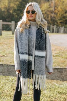 Wrap up in style with the Black Multi Stripe Fringe Scarf, a versatile accessory that adds warmth and flair to any outfit! Made from a brushed fabric, it offers a soft and cozy feel that’s perfect for cooler weather. The oblong shape makes it easy to style in a variety of ways, whether draped over your shoulders or wrapped around your neck. Featuring a multi-striped pattern, this scarf is both eye-catching and effortlessly chic. Revival Clothing, Fall Style Guide, Gameday Dress, Loungewear Dresses, Casual White Dress, Game Dresses, Fringe Scarf, Cooler Weather, Basic Tops