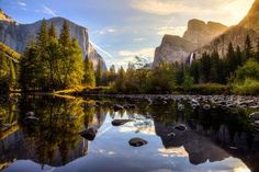 the sun shines brightly over yosep mountain and its reflection in the water