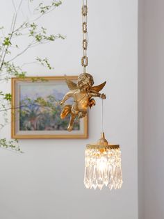 an angel figurine hanging from a chandelier