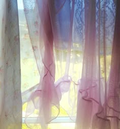 the curtains are open and ready to be hung in the window sill with lace on them