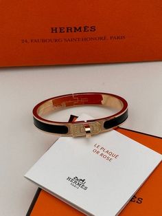 Gender: Women Brand: HERMES Product Name: Mini Clic Kelly Bracelet Gold Black Bags Alora Code: 85881152 Color: black Composition: Metal Origin: France Features: Bangle Bracelet Designer Style ID H200004FO01 Luxury Adjustable Black Enamel Bracelets, Designer Black Enamel Jewelry, Designer Black Jewelry With Black Enamel, Timeless Black Bracelets, Timeless Black Bangle Jewelry, Luxury Black Enamel Bracelet As Gift, Luxury Black Bracelets, Modern Black Bracelets With Palladium Hardware, Designer Gold Bracelets With Black Enamel