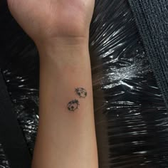 a woman's arm with a tattoo on it that has two panda bears in the middle