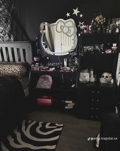 a black and white bedroom with zebra print bedding, dressers, and mirror