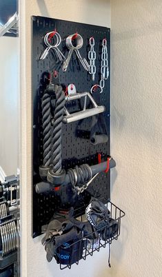 Black Wall Control Pegboard holding gym equipment accessories. Gym Wall Organization Ideas, Gym Wall Accessories, Diy Home Gym Storage, Boxing Room Ideas, Garage Gym Storage, Garage Gym Organization Ideas, Gym Wall Organizer, Gym Wall Ideas, Small Workout Room Ideas