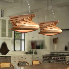 two wooden lights hanging from the ceiling in a kitchen