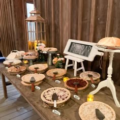 several pies on a table in front of a sign