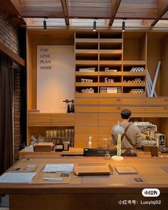 a man sitting at a desk in front of a bookshelf