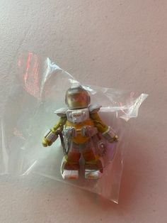 a small toy is sitting in a plastic bag