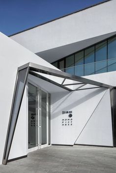 the entrance to an office building with white walls