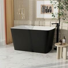 a bathroom with a black bathtub next to a table and potted plant in the corner