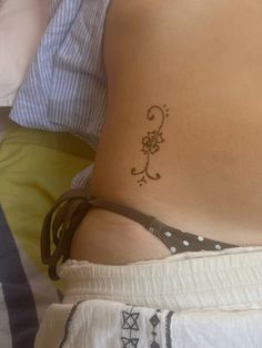 a woman's stomach with a tattoo on her belly and the bottom part of her lower body