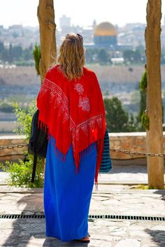 a woman wearing a red and blue shawl