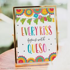 there is a sign that says every kiss begins with queso