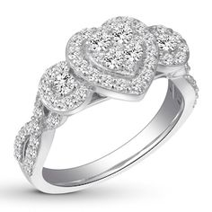 a diamond heart shaped ring with three diamonds on top