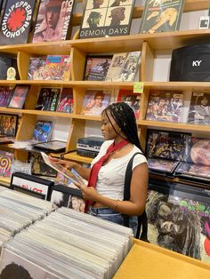 a woman standing in front of a record store