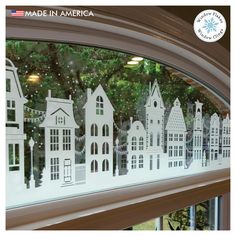 the window is decorated with white paper houses