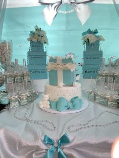 a blue and white wedding cake sitting on top of a table