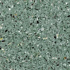 an image of a green surface with lots of small holes in it and some rocks on the ground