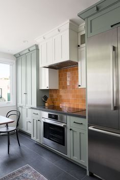 a kitchen with an oven, dishwasher and refrigerator