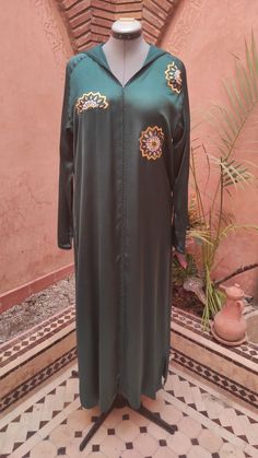 Traditional Silk Abaya For Eid, Traditional Long Sleeve Silk Embroidered Dress, Silk Embroidered Long Sleeve Dress For Eid, Traditional Green Abaya For Eid, Traditional Long Green Abaya, Traditional Long Thobe With Floral Embroidery, Traditional Silk Abaya, Traditional Long Silk Abaya, Traditional Long Sleeve Silk Kaftan