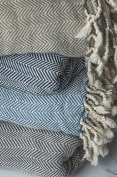 two blue and white blankets folded on top of each other