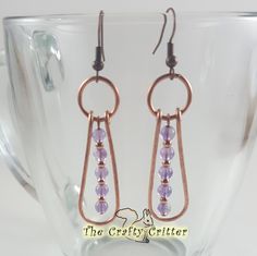 Bright copper and light purple amethysts work so well together!  The amethysts are separated  by small copper beads and surrounded by hammered copper wire.  The group is then held together with a large jump ring.  Hammered metal has such a wonderful texture! The earrings measure approximately 1 ¾" from the top of the weave to the bottom of the earring.  This measurement does not include the ear wires. Colors may appear different than they actually are depending on your monitor color settings and the lighting used during photography. Gemstone Properties: Amethysts are associated with: *Addiction Recovery *Alcoholism Recovery *Awareness *Balance *Communication *Love *Meditation *Relief from Acne *Relief from Anger *Relief from Fear *Well Being *Wisdom Every item I create is made with great c Purple Amethyst Earrings, Wire Jewelery, Wire Wrap Jewelry Designs, Bijoux Fil Aluminium, Earrings Wire, Wrapped Earrings, Earrings Purple, Wire Wrapped Earrings, Hammered Copper