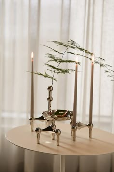 a candle holder with three candles on it