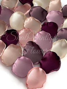 several different shades of purple, pink and white satin petals on a white background with the words silk flowers written below them