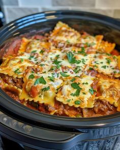 a crock pot filled with lasagna casserole