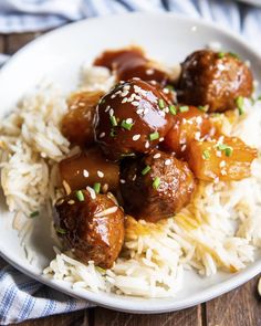 a white plate topped with meatballs and rice