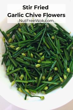 stir fried garlic chive flowers in a white bowl with text overlay that reads, stir fried garlic chive flowers