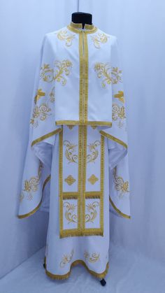 Embroidered Priest vestment set, Priest robes, Religious Clothing  PLEASE be sure to indicate your height in the order notes when purchasing Embroidery type: machine embroidery Model: F54 - Felon made of white gabardine is decorated with machine embroidery lurex threads of golden hue. - The vestment is decorated with floral motifs, curls and angels, as well as large (on the back) and small crosses. - At the edges of the clothes for the priest is decorated with a wide decorative border. - The set Luxury White Vestments With Floral Embroidery, Priest Robes, Church Attire, Vintage Shawls, Type Machine, Decorative Borders, Small Crosses, Floral Motifs, Floral Motif