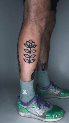 a man's legs with tattoos on them