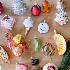 christmas ornaments are arranged on a wooden table