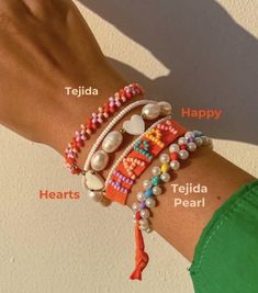 a woman's arm with bracelets and beads on it, labeled in different languages