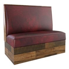 a red leather chair sitting on top of a wooden block with wood trimmings