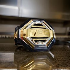 a gold and black wrestling ring sitting on top of a counter