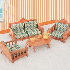 a doll house living room with furniture and accessories on the floor in front of a striped wall