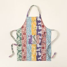 an apron made out of colorful fabric on a white background with a tie around the neck