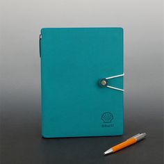 a notebook and pen sitting on a table