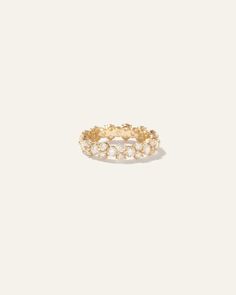 a gold ring with small white stones