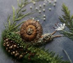 a close up of a piece of fabric with plants and leaves on it, including an acorn