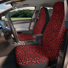 the interior of a car with red and black leopard print seat covers on it's front seats